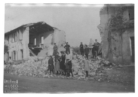 Alcuni abitanti ritratti sulle rovine di edifici distrutti durante la Prima guerra mondiale