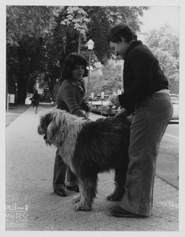 Giacomo con un'amica accarezza un cane